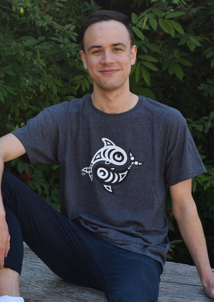 Model wearing a grey t-shirt with a circular design on the chest of a black orca and white orca.
