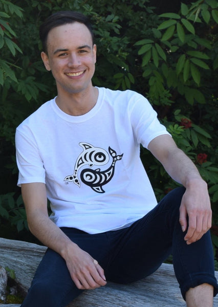 Model wearing a white t-shirt with a circular design on the chest of a black orca and white orca.