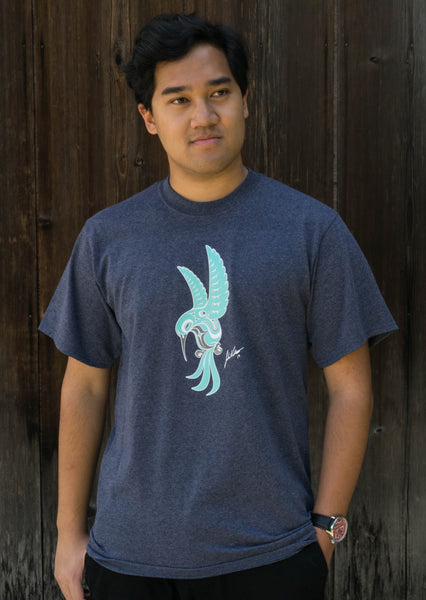 Model wearing a heather blue t-shirt with a turquoise hummingbird with white and grey details, printed on the chest.