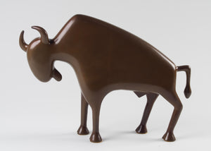Smooth, brown bronze sculpture of a buffalo in side profile, with an abstract angular shape.